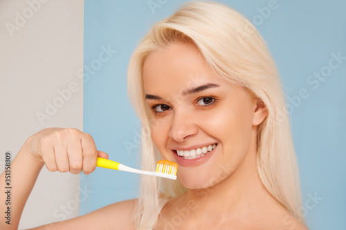 Woman with beautiful smile  healthy white teeth with toothbrush. High resolution image