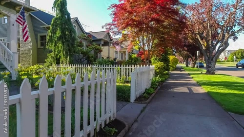 Walking along an American suburban neighborhood sidewalk on a sunny spring day photo