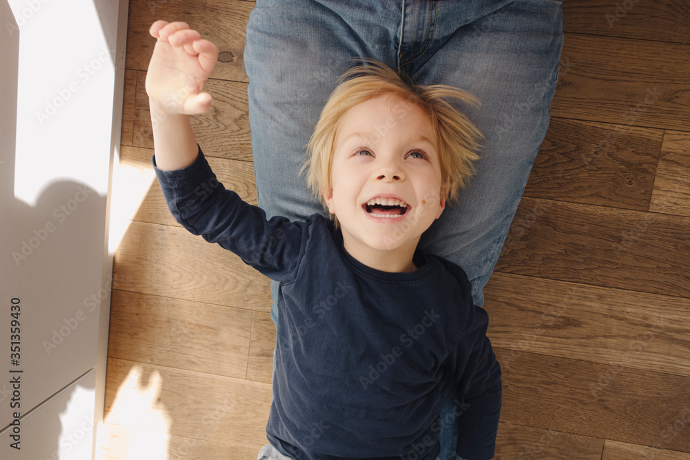 Portrait of happy little boy playing with his father at home Portrait of happy little boy playing with his father at home