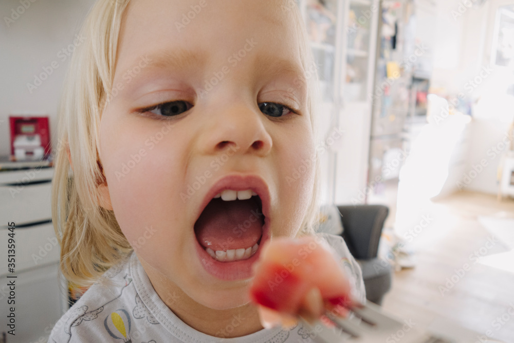 Portrait of blond little girl with open mouth