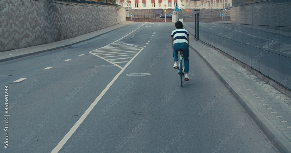 Fototapeta premium Young hipster man riding bike