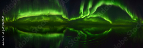 180 degree panorama of the Northen Lights (Aurora Borealis) over the ocean, Nunavut and Northwest Territories, Canada, North America