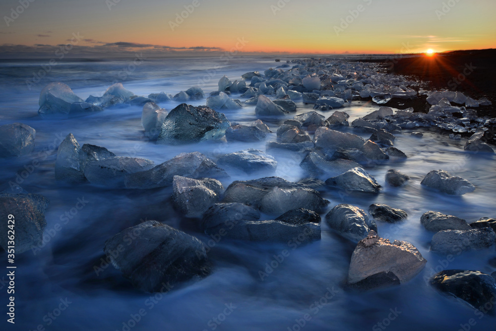 Pieces of glacial ice over black sand being washed by waves, Iceland, Polar Regions Pieces of glacial ice over black sand being washed by waves, Iceland, Polar Regions