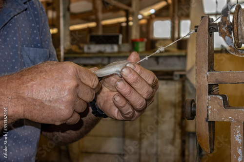 A Farmer Making Yarn out of Wool © Moshe Einhorn