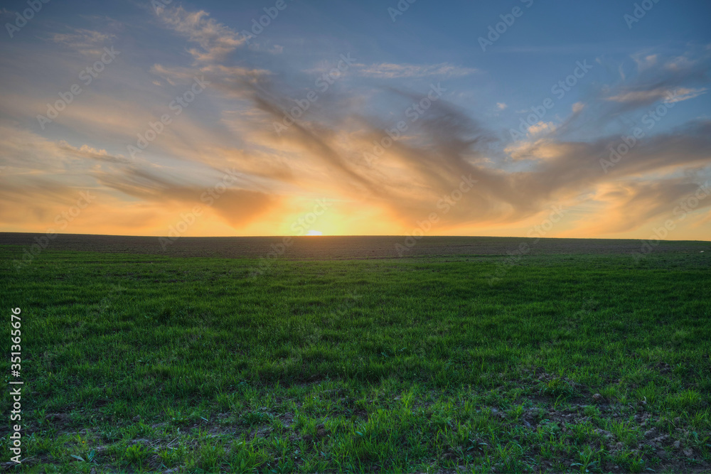 sunset over a freshly plowed field