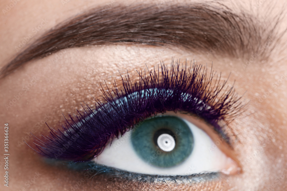 Fototapeta premium Young woman with color eyelashes and beautiful makeup, closeup