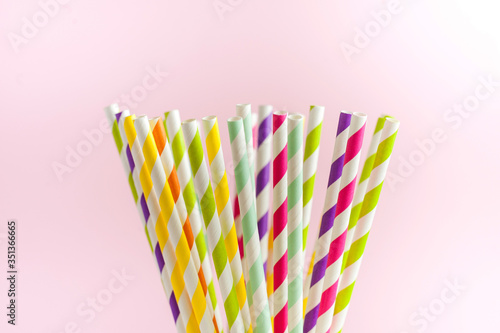  Multi-colored striped paper tubes for drinks, cocktails. The concept of party, celebration, birthday. Copy space.