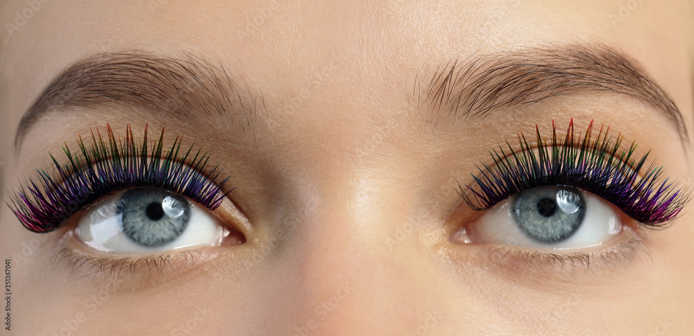 Obraz premium Young woman with long color eyelashes, closeup. Banner design