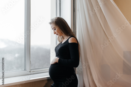 A pregnant girl is breathing fresh air from the window Free Download A pregnant girl is breathing fresh air from the window - GFXLoad