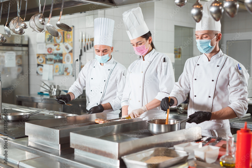 team of cooks cooks in a restaurant. team of cooks cooks in a restaurant.