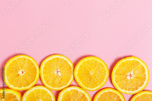  sliced ​​orange on a pink background. The concept of healthy food, Vitamin C. copy space