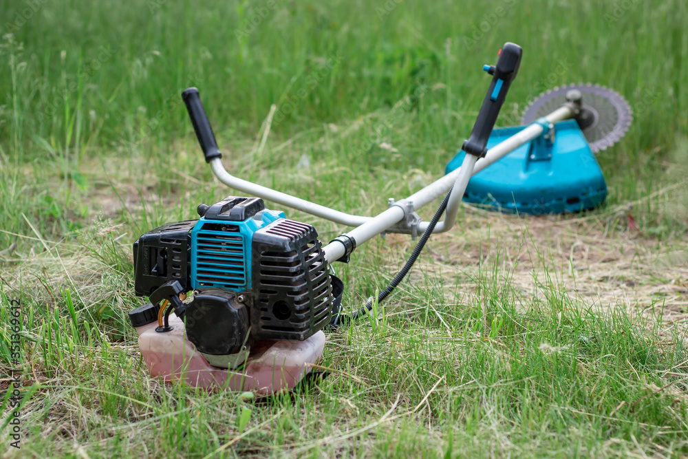 grass trimmer, lying on the ground
