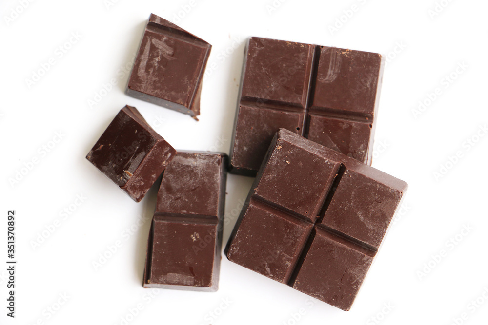 Broken blocks of milk chocolate isolated on a white background with space for text Broken blocks of milk chocolate isolated on a white background with space for text