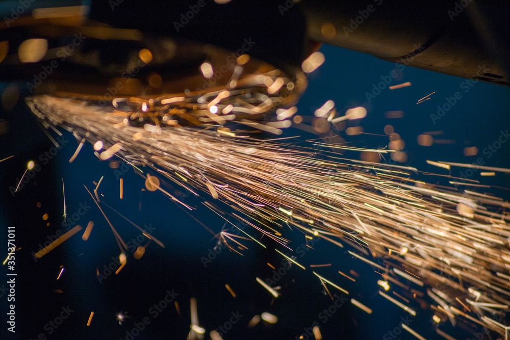 flying sparks from grinding metal, work with a manual grinder,
