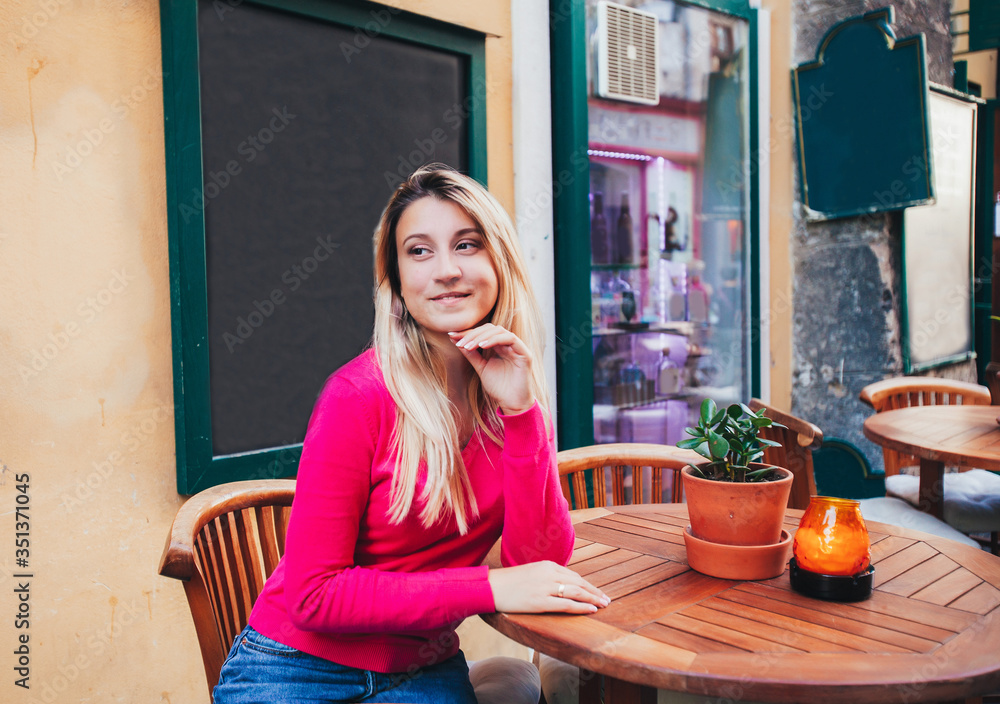 woman sitting at a table in a cafe
woman sitting at a table in a cafe