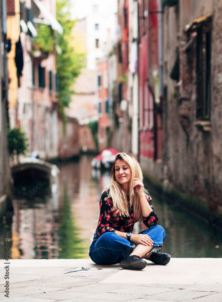 girl sitting on a street of Venice