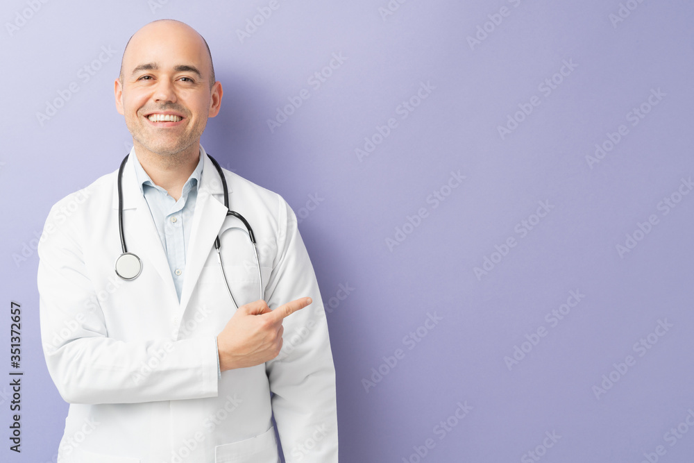 Male doctor pointing at copy space Male doctor pointing at copy space