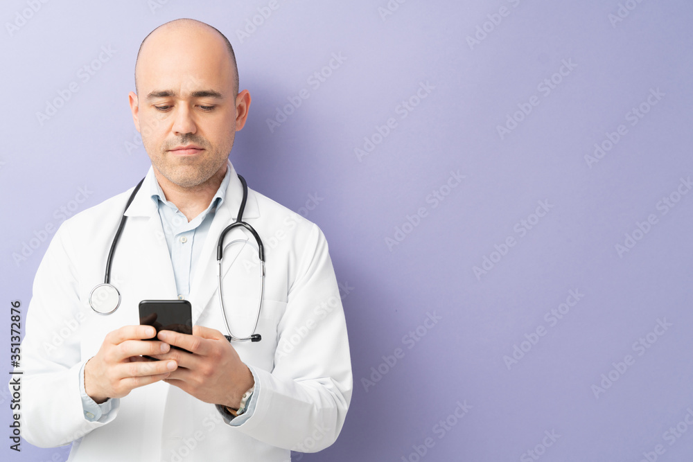 Physician using smartphone in a studio Physician using smartphone in a studio