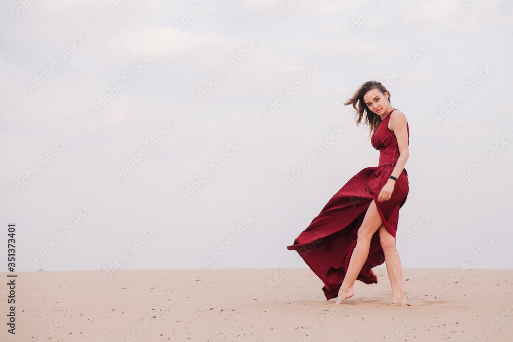 Girl in red dress at sunset in the desert Girl in red dress at sunset in the desert
