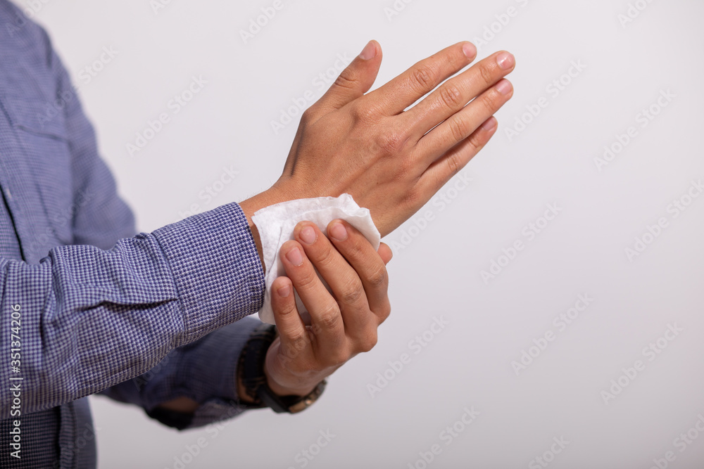 Fototapeta premium Man cleaning hands with wet wipes