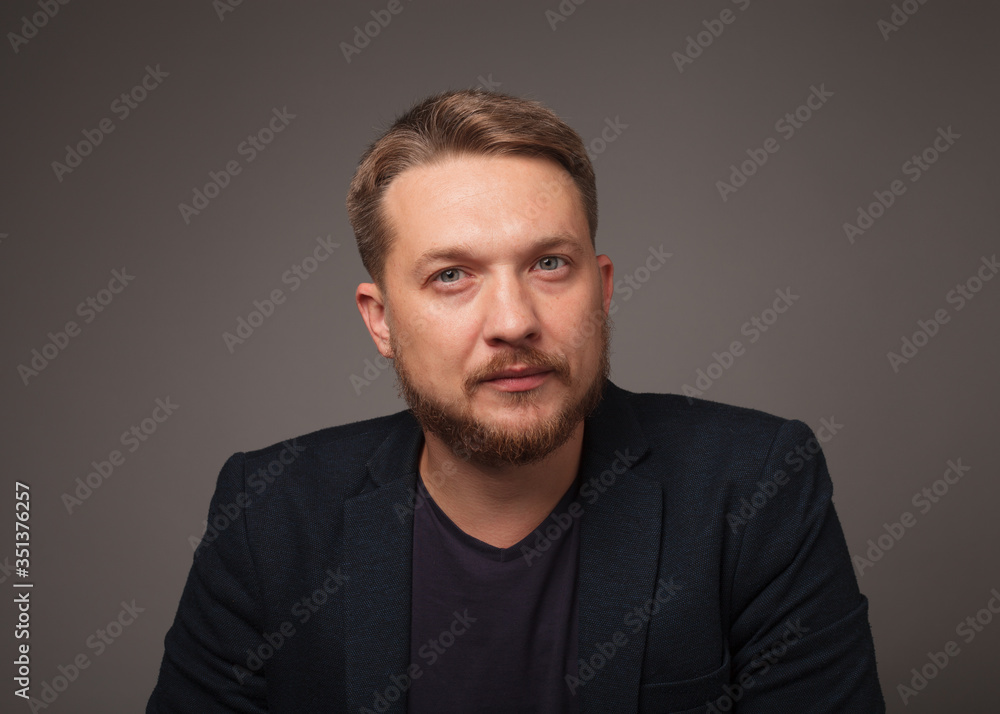 Handsome man over dark background looking at camera