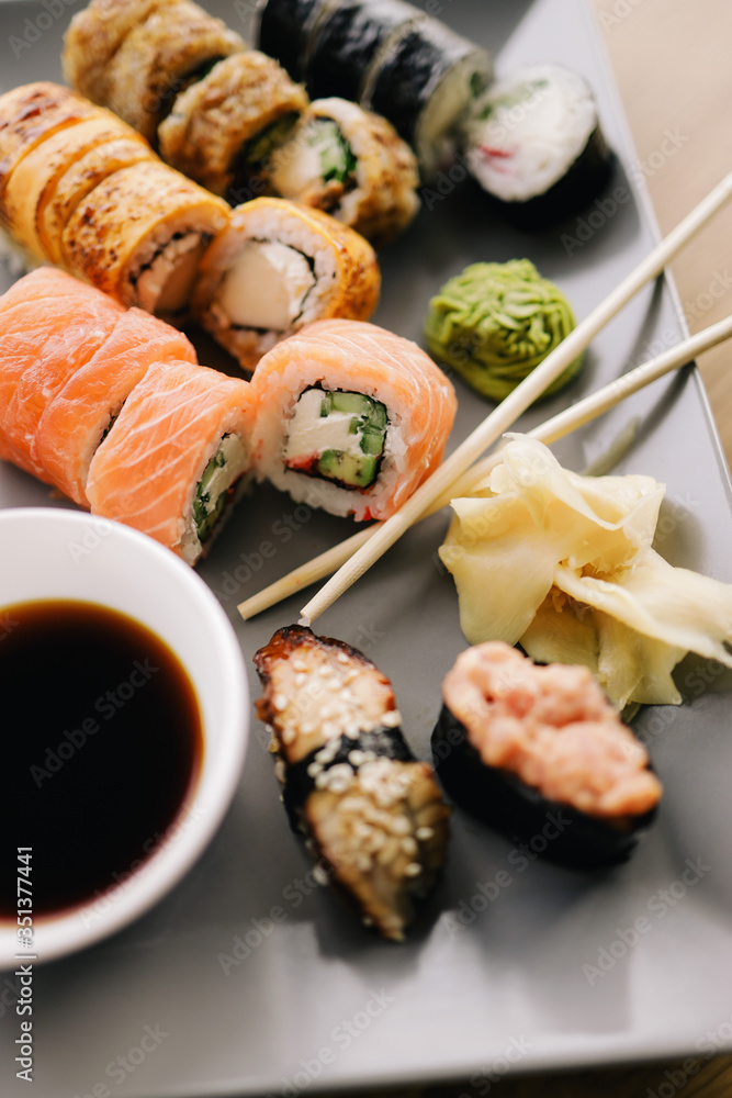 Freshly cooked sushi chef, delicious big rolls with avocado, cheese, salmon, sesame seeds Freshly cooked sushi chef, delicious big rolls with avocado, cheese, salmon, sesame seeds