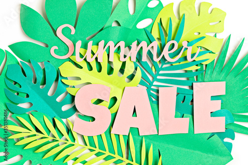 Word Sale over tropical paper cut leaves background. Summer sale, online deals, discounts