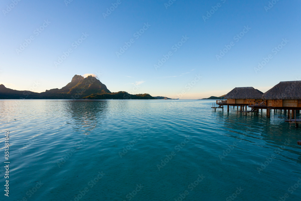 Naklejka premium Bora Bora lagoon with overwater huts at sunrise