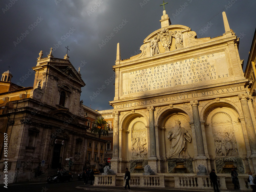 Rome, Italy: the last rays of sunlight before the storm illuminate the fountain of Moses in Rome