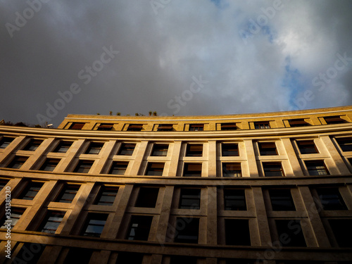 Rome, Italy: a building is illuminated by rays of sunlight before the storm