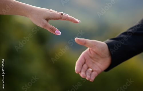Hands of the bride and groom on a wedding day  © TsarPro