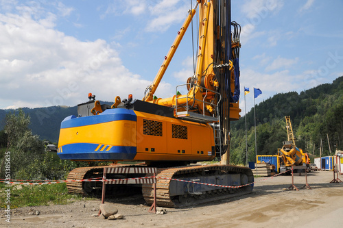 Crawler drilling machine with equipment for the production of large diameter bored piles at a construction site.