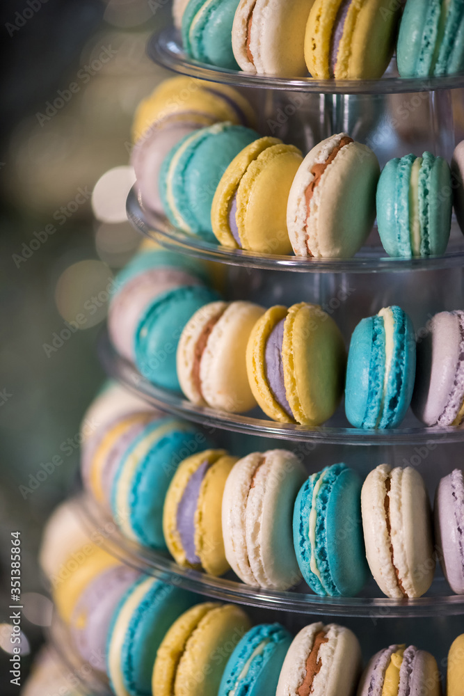 Different types of delicious, colorful french macaroons on a dessert buffet table.