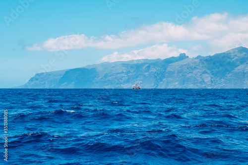 Ship against the background of mountains in the Atlantic ocean. Canary Islands  Los Gigantes