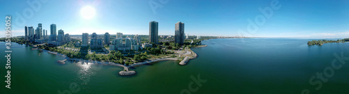 Humber Bay Shores Park city views, green space with skyline cityscape downtown. Skyscrapers over The Queensway on sunset at summer time, near Etobicoke or New Toronto, Ontario, Canada photo