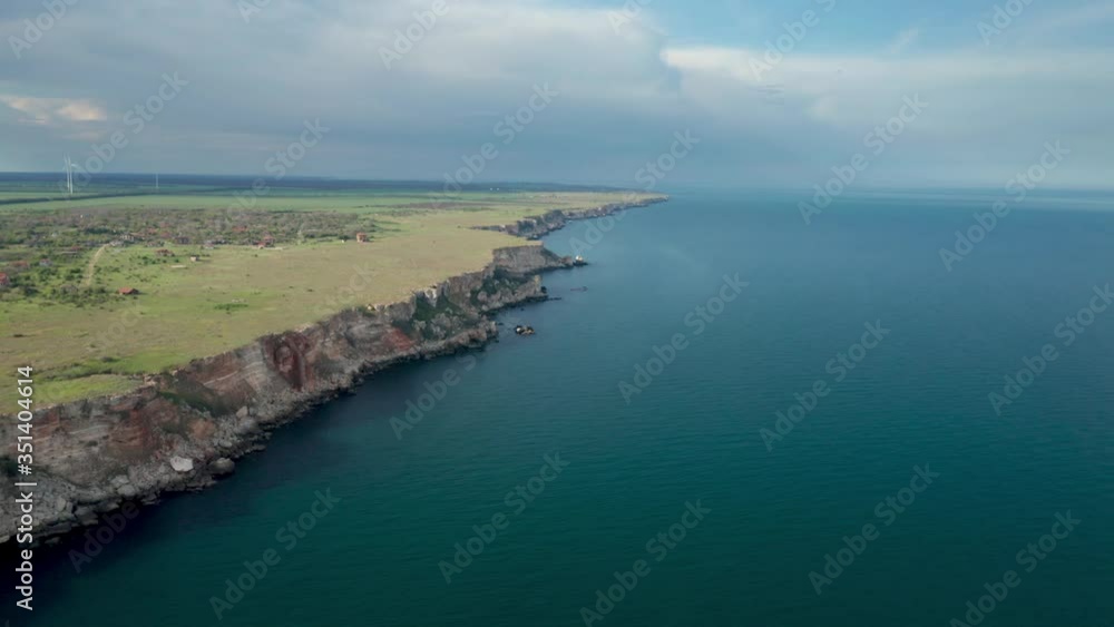 Panoramic video of picturesque rocky coastline with green fields and trees. Spring time at the Black sea coast, Yailata - national archeological and nature reserve, Bulgaria. Panoramic video of picturesque rocky coastline with green fields and trees. Spring time at the Black sea coast, Yailata - national archeological and nature reserve, Bulgaria.