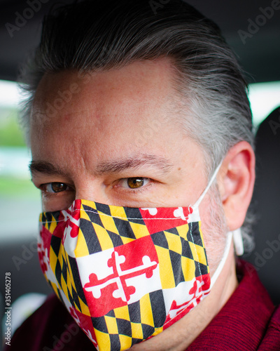 portrait of a man with the flag of Maryland on his mask