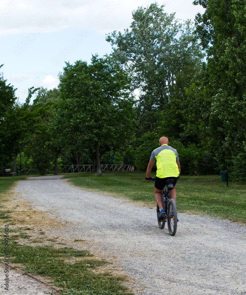 Man cycling in a park in Italy after the coronavirus lockdown