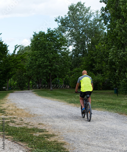 Man cycling in a park in Italy after the coronavirus lockdown