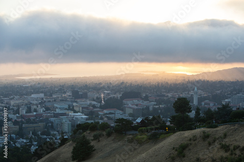 Obraz na płótnie A beautiful sunset occurs over the city and campus of Berkeley which lies on the east shores of San Francisco Bay in Northern California