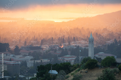 A beautiful sunset occurs over the city and campus of Berkeley which lies on the east shores of San Francisco Bay in Northern California.  photo