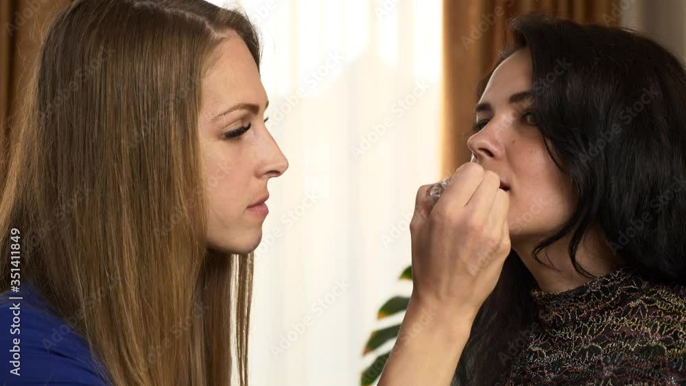 Make-Up Artist Beautician Applying Cosmetics On Caucasian Woman's Face. 2x Slow motion - 0.5 speed 60 FPS Make-Up Artist Beautician Applying Cosmetics On Caucasian Woman's Face. 2x Slow motion - 0.5 speed 60 FPS
