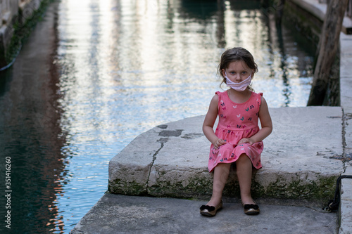 Fototapeta Naklejka Na Ścianę i Meble -   portrait of a cute little girl during the covid-19 epidemy in Venice