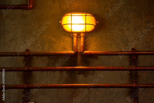 yellow bulkhead light. ship deck lamp. industrial background photo