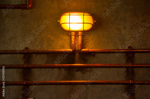 Photos yellow bulkhead light. ship deck lamp. industrial background