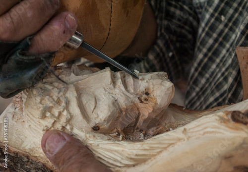 Native Indigenous craftsman working on a Wood carved sculpture of Jesus face Tepatitlan de Morelos, Mexican town photo