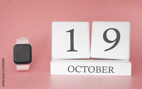 Modern Watch with cube calendar and date 19 october on pink background. Concept autumn time vacation.