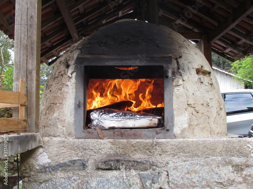 Preparing the roast in the wood oven