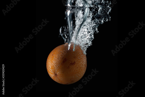 passion fruit entering the water and splashing