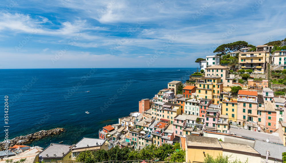 Panoramic view of Riomaggiore town in Cinque Terre and the mediterranean sea, in Italy.